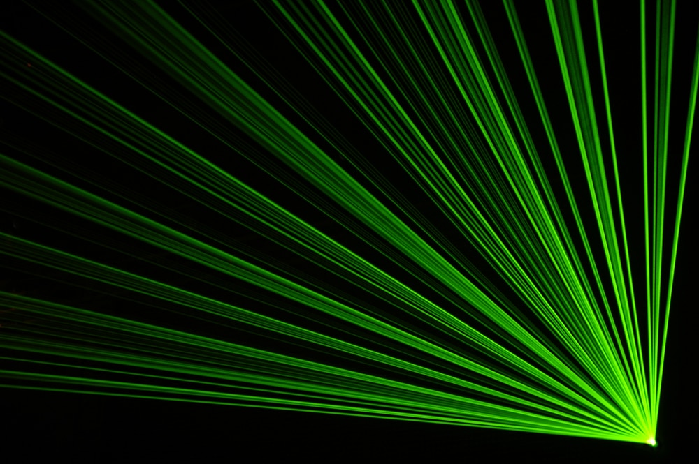 Green laser on a black background.